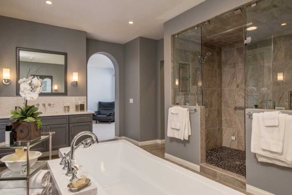 A bathroom with a walk-in shower and a large tub, perfect for a luxurious bathroom remodeling project.