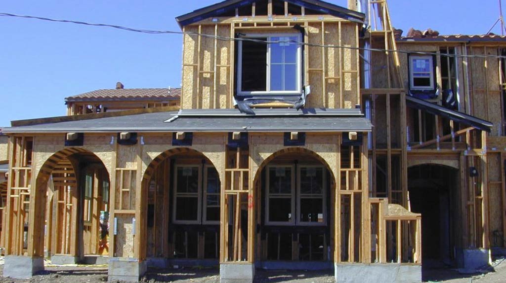 A whole house under construction with wooden framing.
