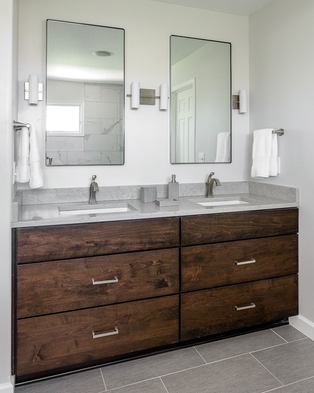 bathroom vanity with dark stained cabinets and quartz top