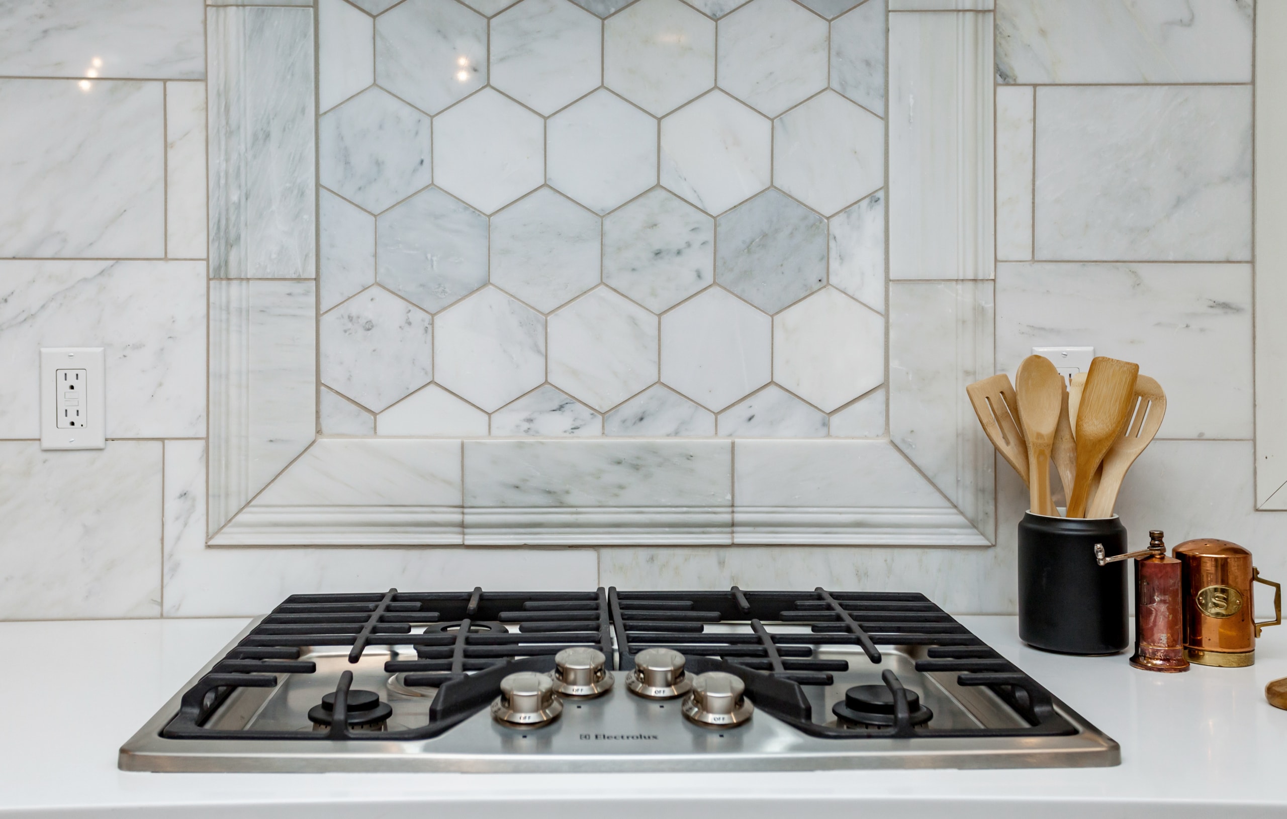 kitchen cooktop with marble backsplash