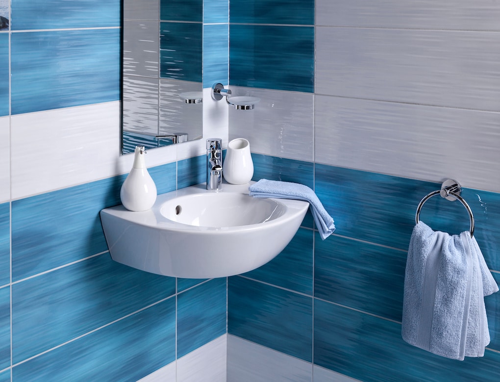 detail of modern oversized colorful tiles included in bathroom floor plan with sink and accessoriesv
