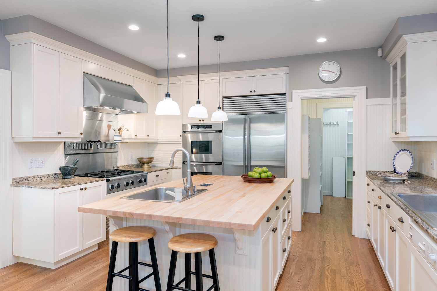 A kitchen with white cabinets and stainless steel appliances in Des Moines.