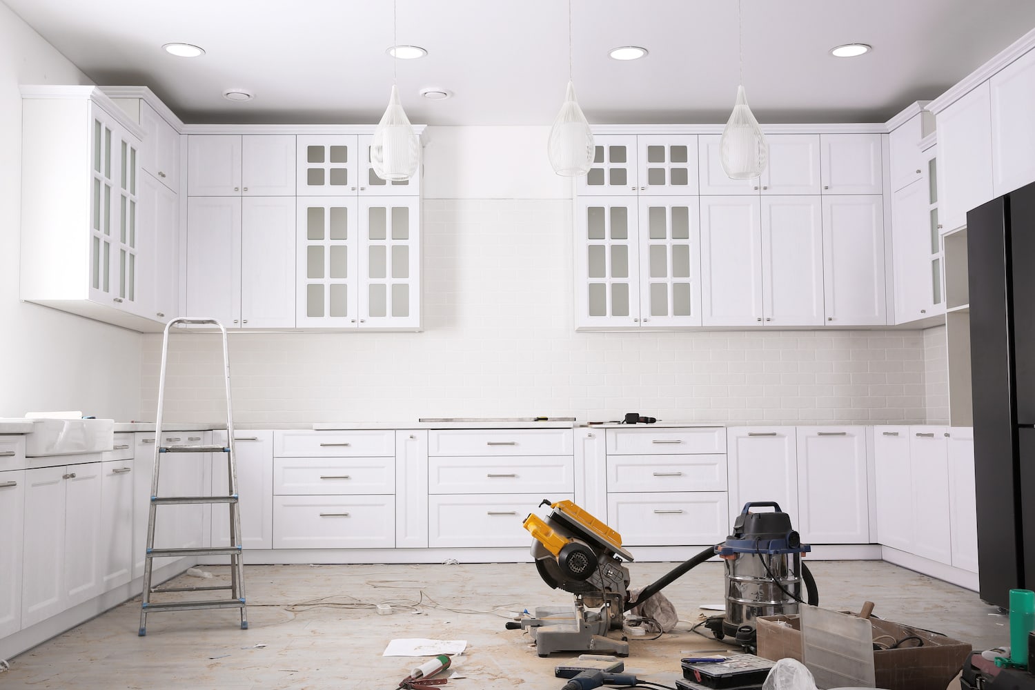 how long does a kitchen remodel take white kitchen mid-renovation with power tools and equipment on floor