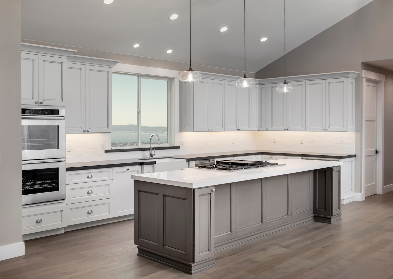 how long does a kitchen remodel take newly finished kitchen with white countertops and gray cabinets