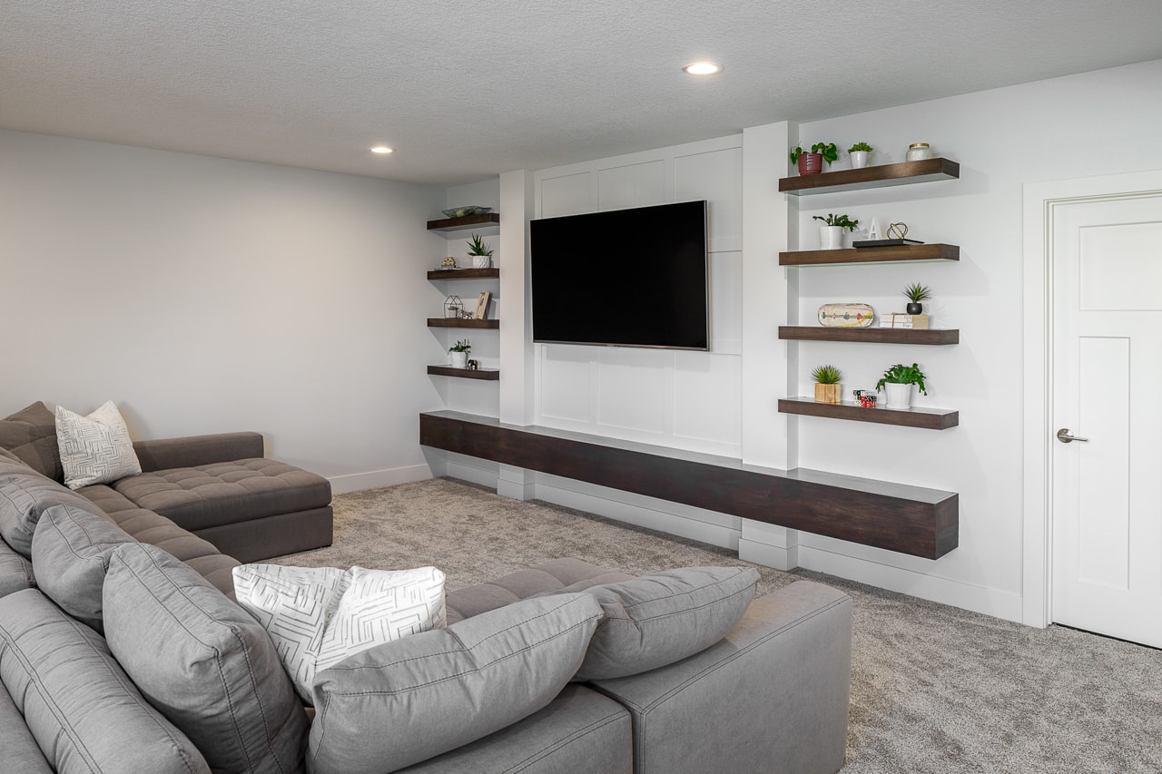 Remodel a gray living room with a tv on the wall.