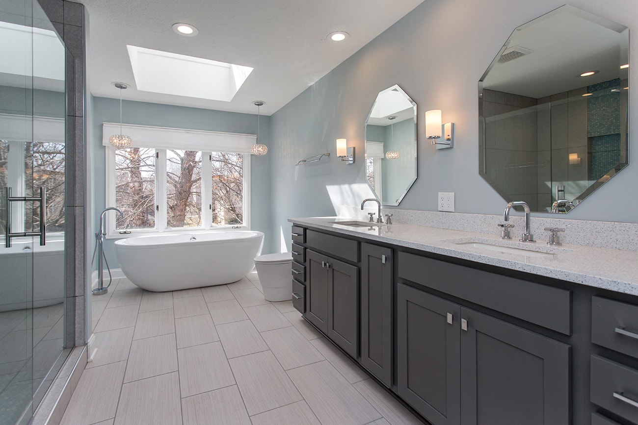 A spacious bathroom with a large tub and sink.