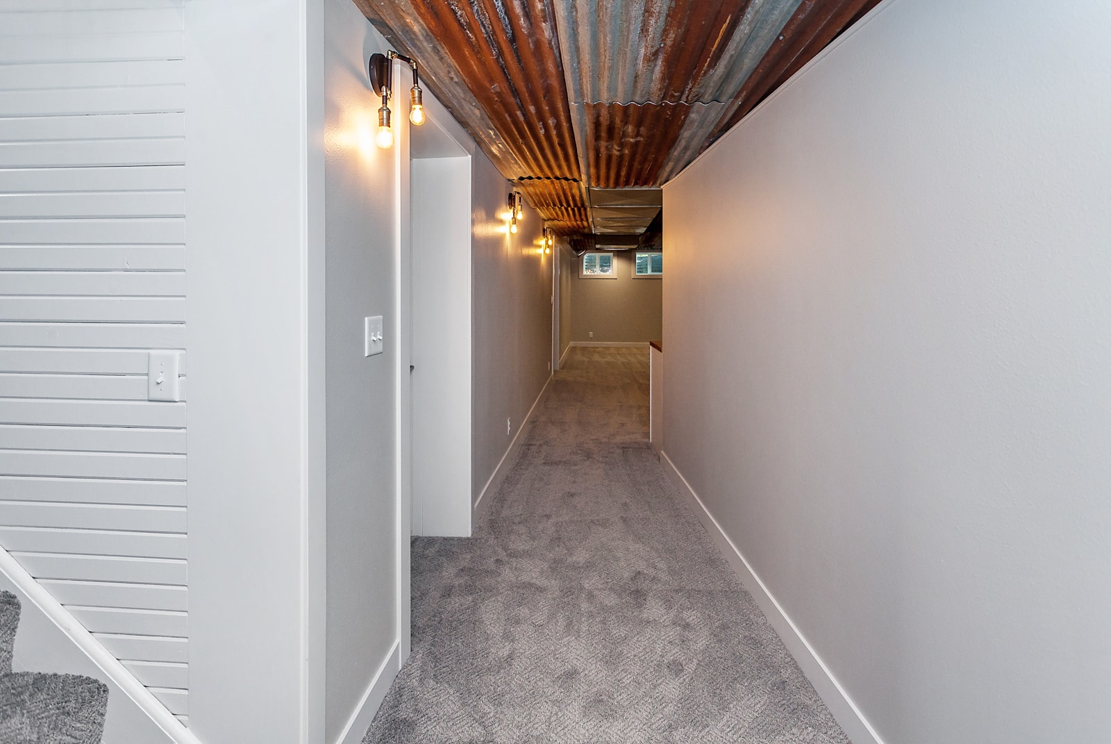 A narrow basement hallway in a home.