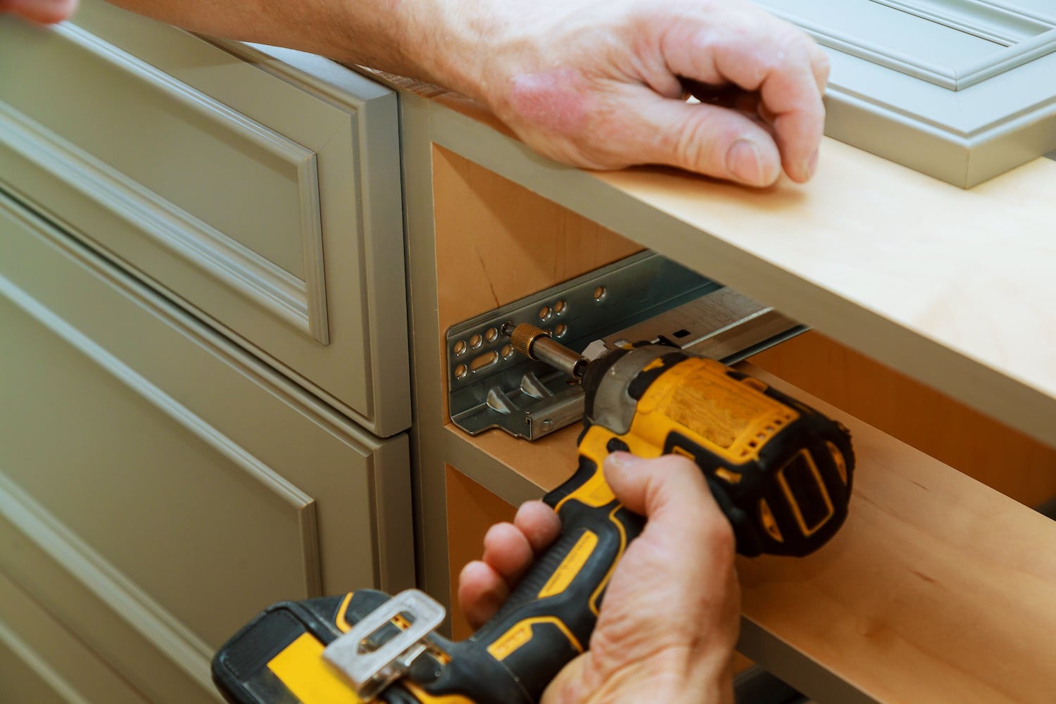 Ankeny Handyman drilling cabinet